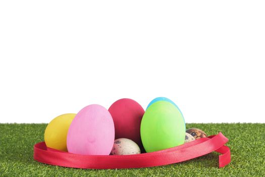 Ester egg on grass over white background