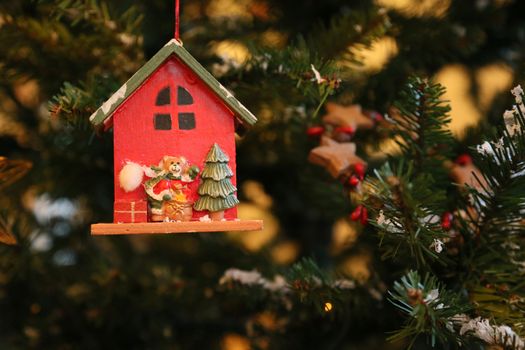Christmas ornament - Bear Santa CLaus is decorating the Cristmas Tree