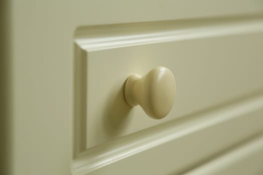 handle of baby's beige chest of drawyers