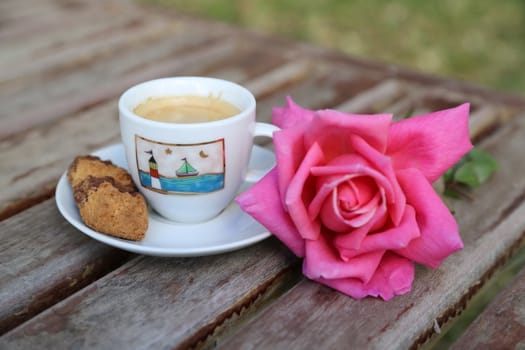 A cup of Italian espresso with a biscuit