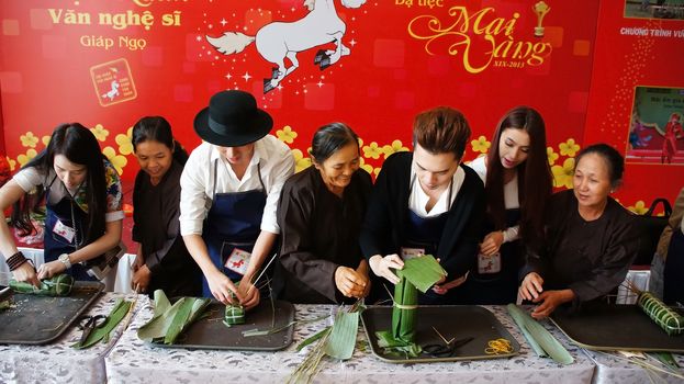 HO CHI MINH CITY, VIET NAM- JAN 15: Artist people in make cake competition, they doing traditional food - banh tet: famous food in Tet (Lunar New Year)- with  joyful and clever, Vietnam, Jan 15, 2013