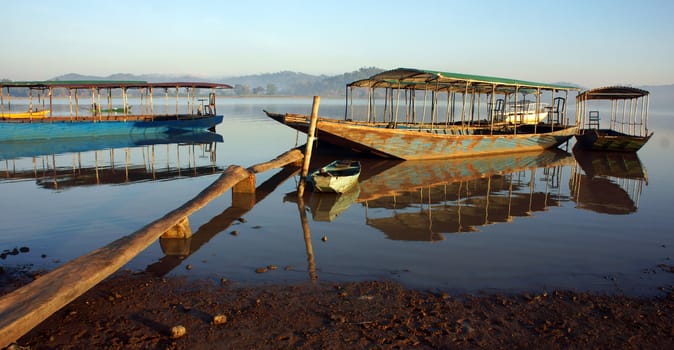  Beautiful landscape with boat reflect on surface water of lake under sunlight at Viet Nam countryside                   