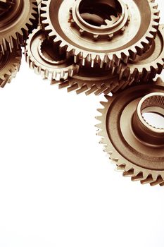 Metal cog gears bonding together on plain background