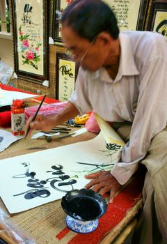 HO CHI MINH CITY, VIET NAM- FEBRUARY 1, 2013. People writing calligraphy at fair, this is traditional culture of Vietnamese in springtime, Sai gon, VietNam on February 1, 2013