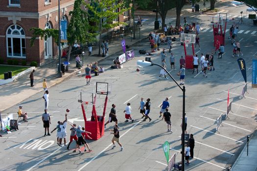 Athens, GA, USA - August 24, 2013:  Several men compete in a 3-on-3 basketball tournament held on the streets of downtown Athens.