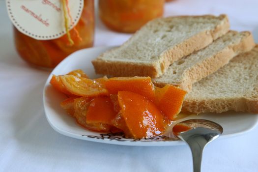 homemade marmalade with pieces of tangerine on the tea plate