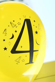 Number four is printed in black on the yellow balloon