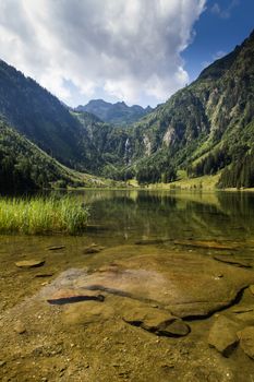 Lake and mountains view in high Alps