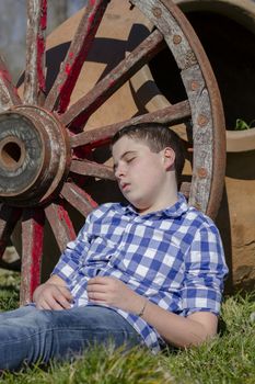 Young boy reading a book in the woods with shallow depth of field and copy space