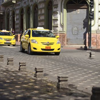 CUENCA, ECUADOR - FEBRUARY 13, 2014: Taxi on the Mariscal Sucre Avenue on February 13, 2014 in the city center of Cuenca, Ecuador