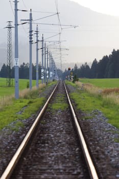 Railroad tracks in high mountains in spring season