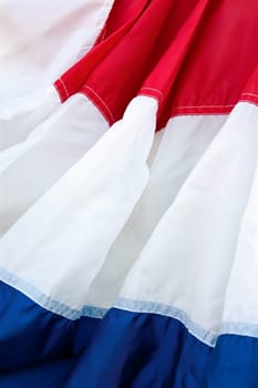 Fabric of red, white, and blue banner fills the frame vertically