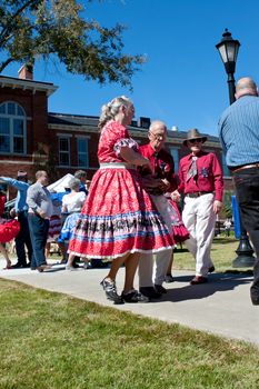 Lawrenceville, GA, USA - October 12, 2013:  A senior citizen couple square dances outdoors at the Old Fashioned Picnic and Bluegrass Festival.  The event was free to the public.