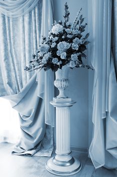 bouquet of beautiful flowers in the vase near the window