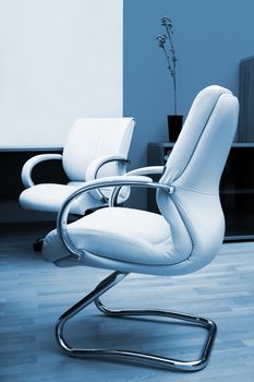 Beige leather armchairs at modern new office