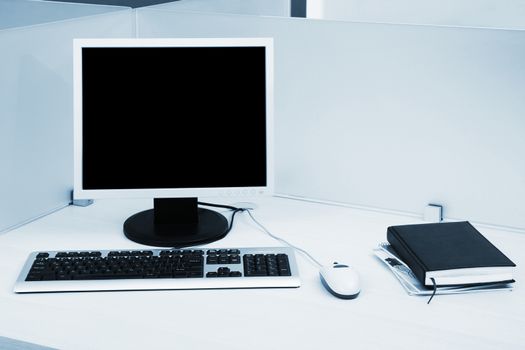 computers behind the glass in a modern office