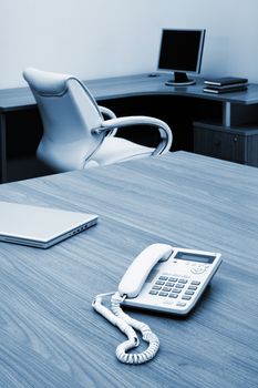 Phone and laptop on a table at modern office