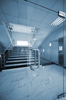 Glass doors with a kind on a marble staircase