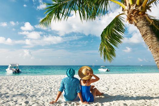 Couple in blue clothes on a tropical beach at Maldives