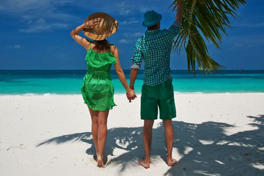 Couple in green on a tropical beach at Maldives