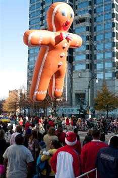 Atlanta, GA, USA - December 1, 2012:  An inflated gingerbread man balloon floats through the parade route at the annual Atlanta Christmas parade in downtown Atlanta.