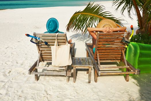 Couple in green on a tropical beach at Maldives