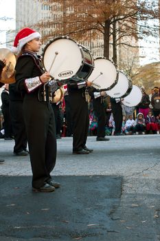 Atlanta, GA, USA - December 1, 2012:   Bass drummers in a high school marching band bang their drums while perfomring in the annual Atlanta Christmas parade in downtown Atlanta.