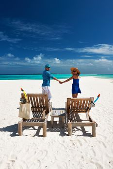 Couple in blue on a tropical beach at Maldives