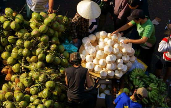 DA LAT, VIET NAM- FEBRUARY 8: People sell and buy coconut at farmers market in  Dalat, VietNam- February 8, 2013