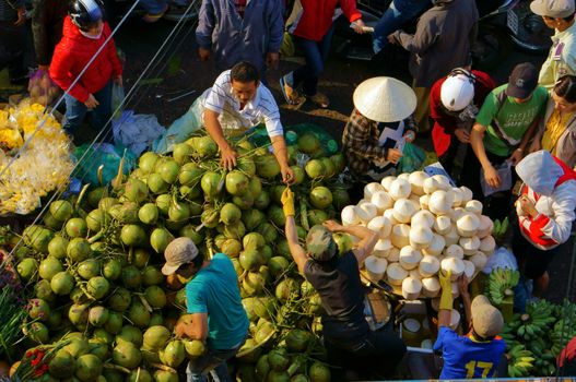 DA LAT, VIET NAM- FEBRUARY 8: People sell and buy coconut at farmers market in  Dalat, VietNam- February 8, 2013