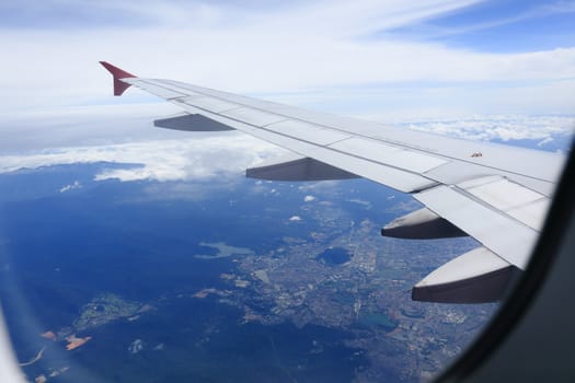 Looking through window aircraft during flight in wing with a nice blue sky