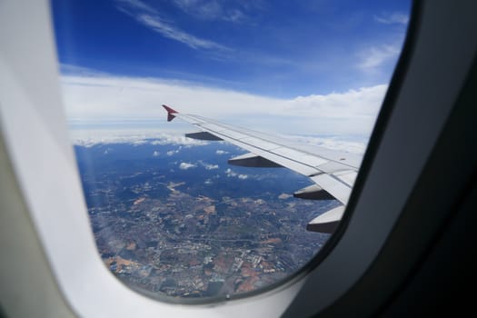 Looking through window aircraft during flight in wing with a nice blue sky