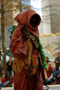 Atlanta, GA, USA - December 1, 2012:  A Jawa character from the Star Wars movies walks down Peachtree Street while taking part in the annual Atlanta Christmas parade in downtown Atlanta.