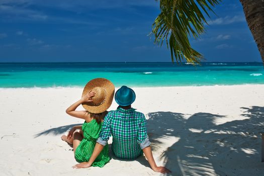 Couple in green on a tropical beach at Maldives