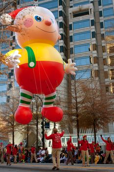 Atlanta, GA, USA - December 1, 2012:  Workers use ropes to guide a huge float along the parade route in the annual Atlanta Christmas parade in downtown Atlanta.