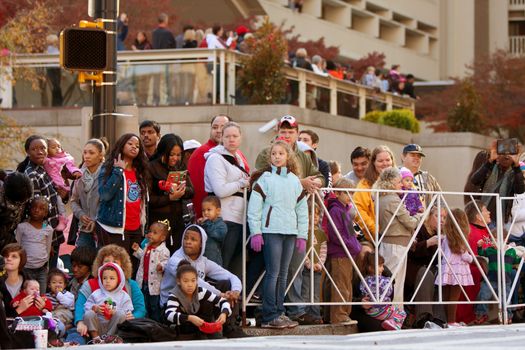 Atlanta, GA, USA - December 1, 2012:  Spectators watch from the street curb as the Atlanta Christmas parade takes place down Peachtree Street in downtown Atlanta. Thousands were on hand for the annual event. 