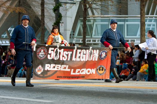 Atlanta, GA, USA - December 1, 2012:  Members of the 501st Rebel Legion carry banner ahead of Star Wars characters taking part in the annual Atlanta Christmas parade in downtown Atlanta.
