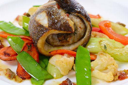 Seabass fillet with spring vegetables and olive