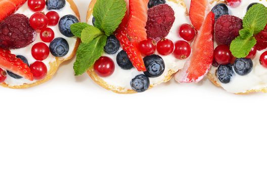 Profiteroles with berries currant  strawberries and blueberries