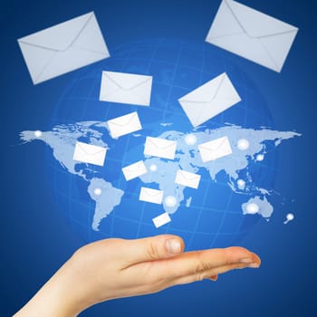 Hand and envelopes. The concept of global contacts
