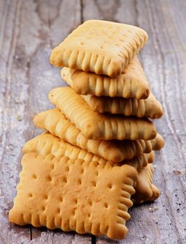 Stack of Crunchy Butter Biscuits closeup on Rustic Wooden background