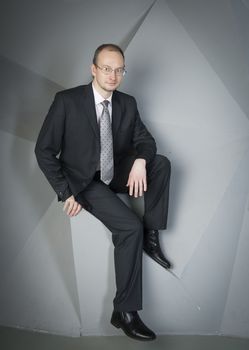  man in a suit and tie on the geometric background