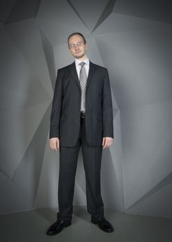  man in a suit and tie on the geometric background