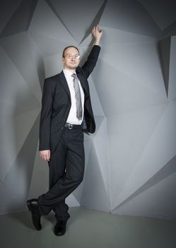  man in a suit and tie on the geometric background