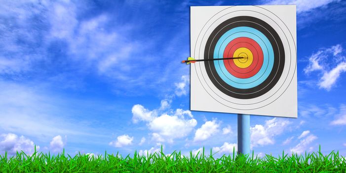 Archery target with arrow over blue sky background