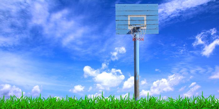 Basketball hoop over a beautiful blue sky background