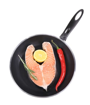 Fresh salmon steak on pan. Isolated on a white background.