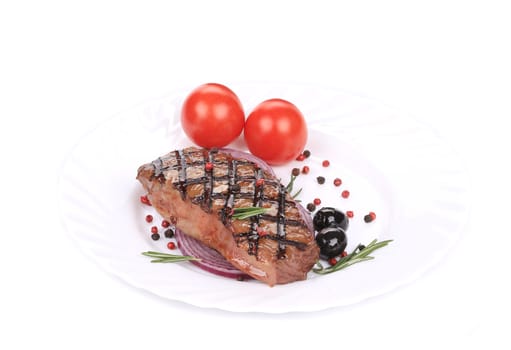 Beef steaks with rosemary and tomatoes. Isolated on a white background.