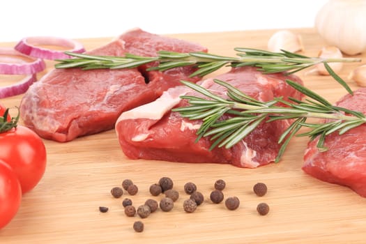 Raw steaks on cutting board. Isolated on a white background.