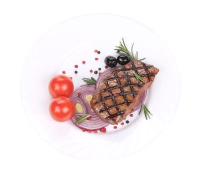 Big juicy grilled steak with greens.